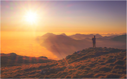 person in mountain seeing the sunset